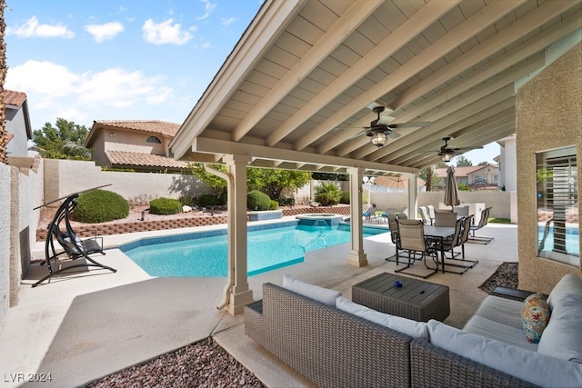 view of swimming pool with an in ground hot tub, an outdoor living space, a patio, and ceiling fan