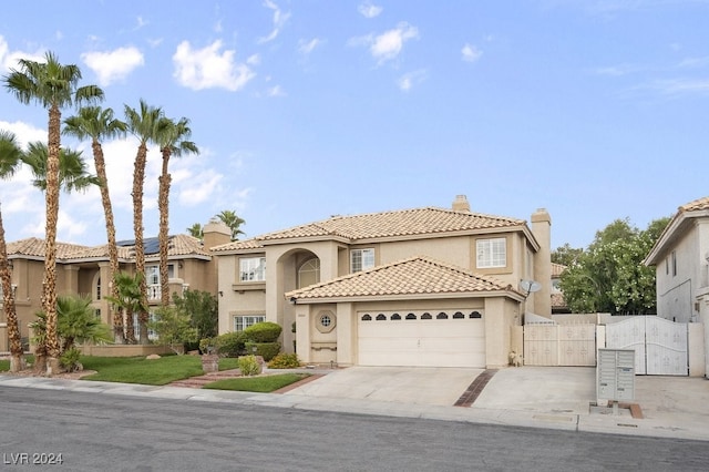 mediterranean / spanish-style house with a garage