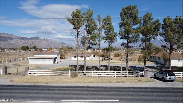 view of front of house featuring a mountain view and a rural view