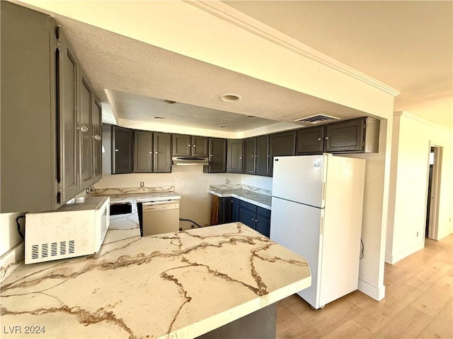 kitchen with kitchen peninsula, white appliances, light hardwood / wood-style floors, and ornamental molding