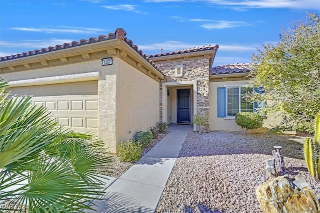 view of exterior entry featuring a garage