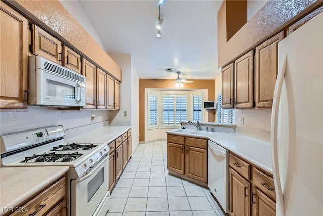 kitchen featuring ceiling fan, sink, kitchen peninsula, white appliances, and light tile patterned floors