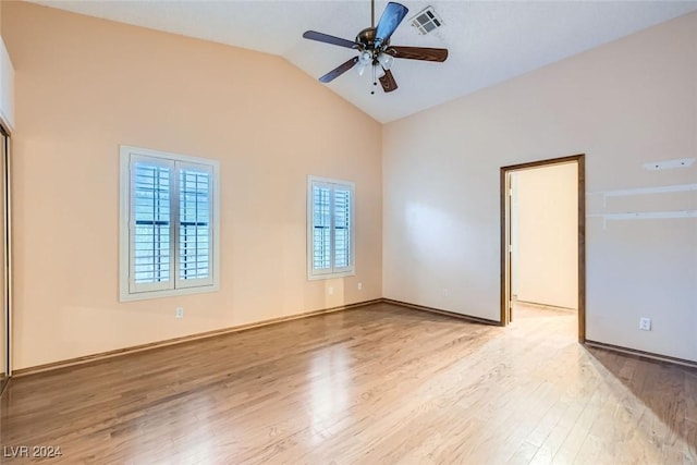 spare room featuring ceiling fan, light hardwood / wood-style flooring, and high vaulted ceiling