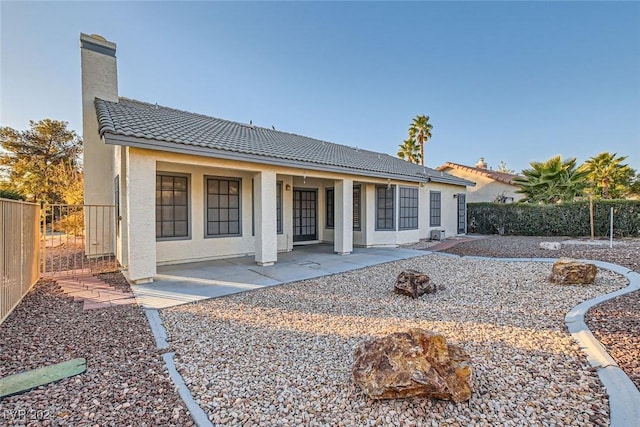 back of house featuring a patio area and an outdoor fire pit