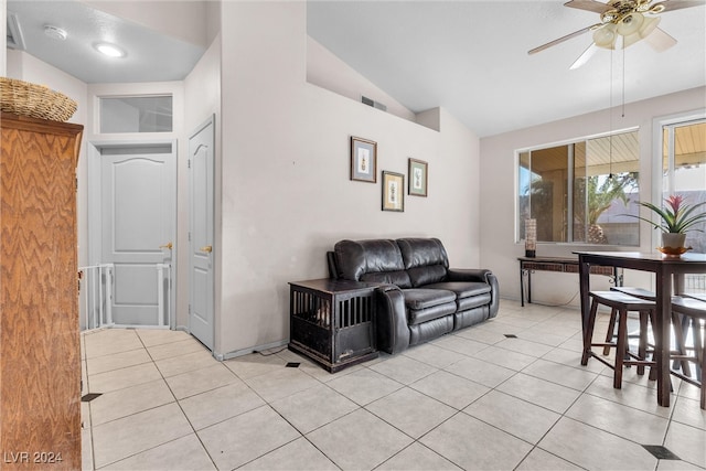 living room with ceiling fan, lofted ceiling, and light tile patterned floors