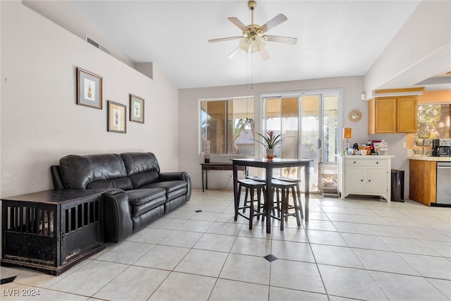 interior space featuring ceiling fan, light tile patterned floors, and vaulted ceiling