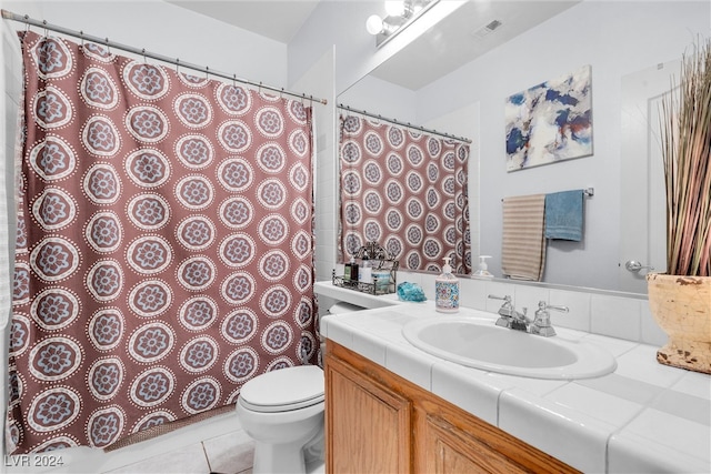 bathroom with tile patterned floors, vanity, and toilet