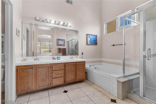 bathroom with tile patterned floors, vanity, and independent shower and bath