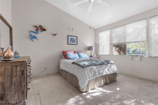 bedroom with ceiling fan, light colored carpet, and vaulted ceiling