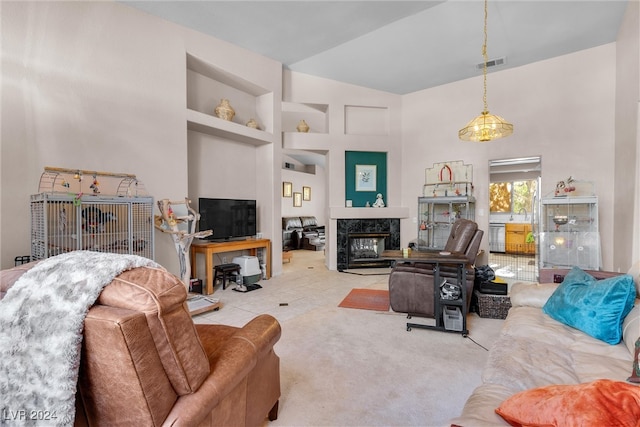 living room featuring built in shelves, a fireplace, and high vaulted ceiling