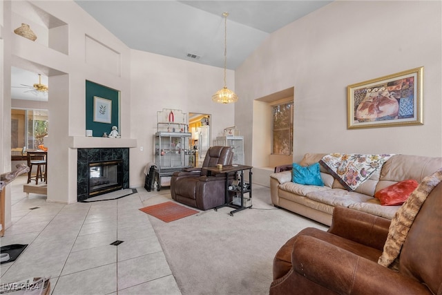 tiled living room with a fireplace, high vaulted ceiling, and ceiling fan