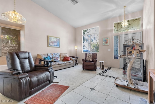 tiled living room featuring high vaulted ceiling and a notable chandelier