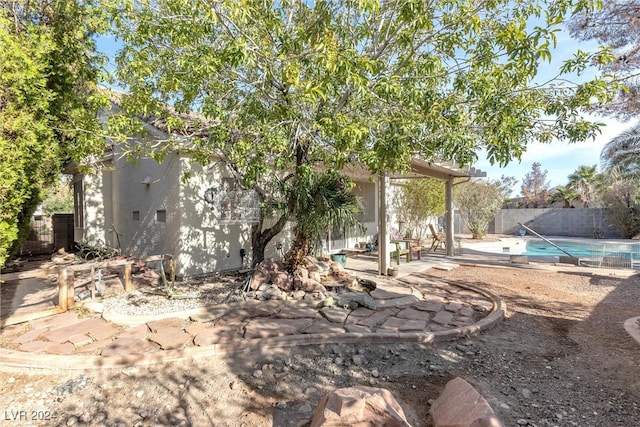 view of yard featuring a fenced in pool and a patio area