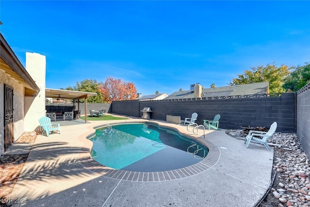 view of pool with ceiling fan and a patio