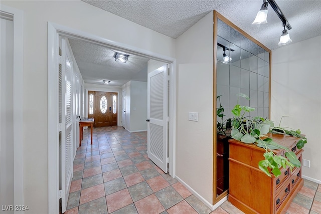 entryway with a textured ceiling