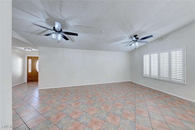 spare room with a textured ceiling and lofted ceiling