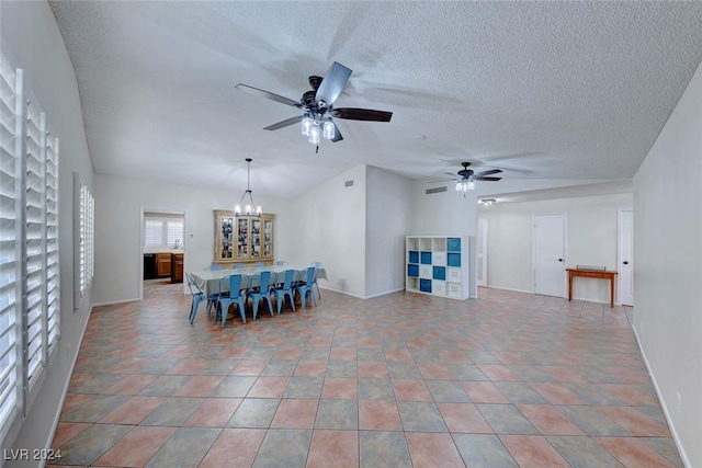 unfurnished dining area with ceiling fan with notable chandelier and a textured ceiling