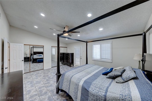 bedroom with a textured ceiling, multiple closets, ceiling fan, and lofted ceiling