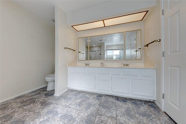 bathroom with an enclosed shower, vanity, and toilet