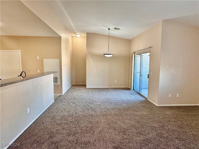 empty room featuring carpet flooring and lofted ceiling