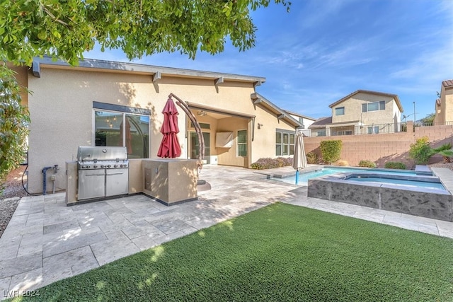 rear view of house featuring a swimming pool with hot tub and a patio area