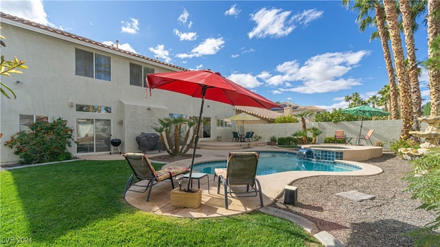 view of pool featuring an in ground hot tub, a patio, and a lawn