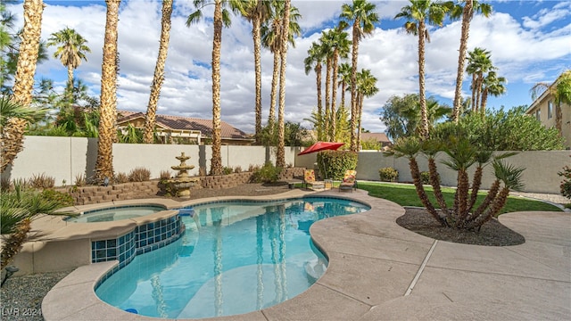 view of swimming pool with an in ground hot tub and a patio