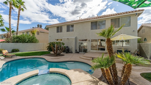 view of swimming pool with an in ground hot tub and a patio