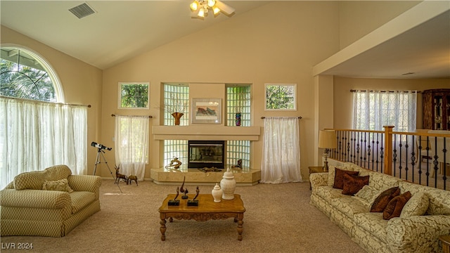 carpeted living room featuring high vaulted ceiling, plenty of natural light, and ceiling fan