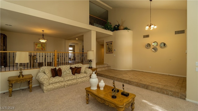 carpeted living room with high vaulted ceiling and a notable chandelier