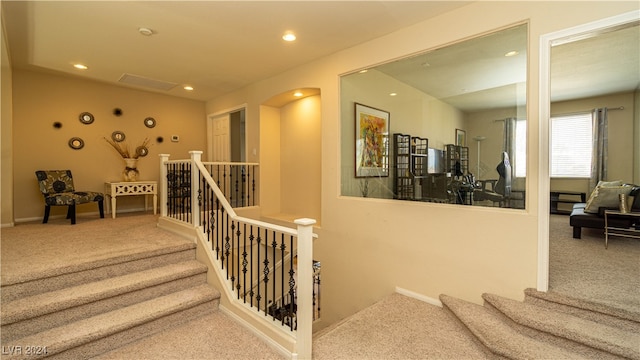 staircase with carpet floors