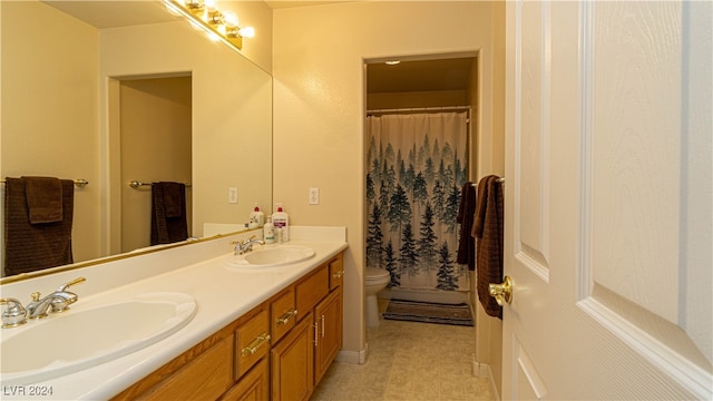 bathroom with curtained shower, tile patterned flooring, vanity, and toilet