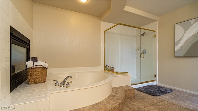 bathroom featuring shower with separate bathtub and tile patterned floors