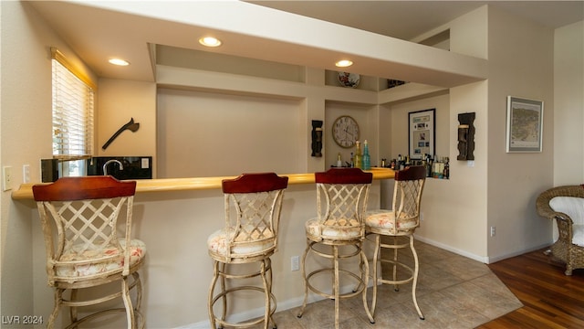 bar featuring dark hardwood / wood-style floors