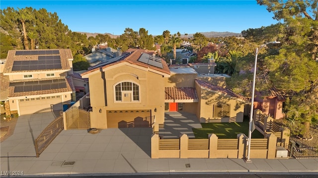 view of front of property with solar panels, a garage, and a front yard