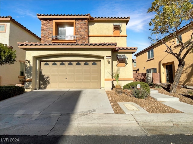 mediterranean / spanish-style house with a garage