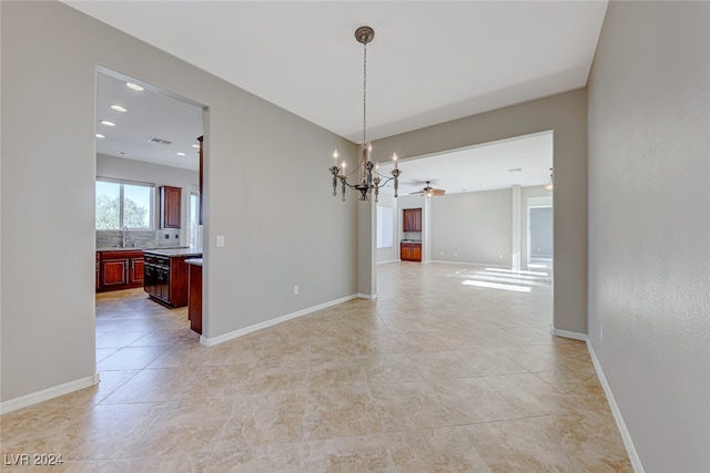 unfurnished dining area featuring ceiling fan with notable chandelier and light tile patterned flooring