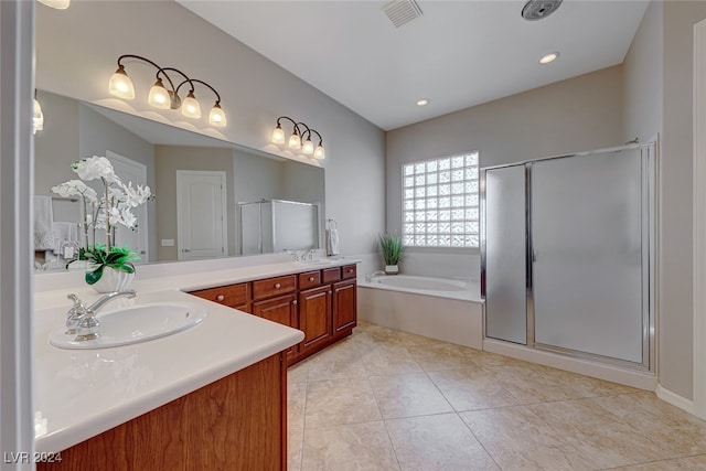 bathroom with tile patterned flooring, vanity, and independent shower and bath