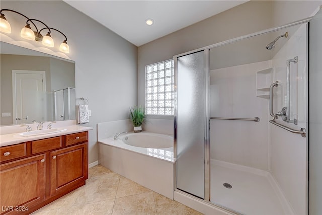 bathroom featuring tile patterned flooring, vanity, and independent shower and bath