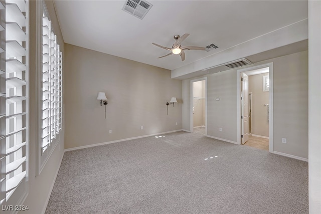 unfurnished room featuring ceiling fan and light carpet