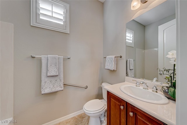 bathroom with tile patterned floors, vanity, and toilet