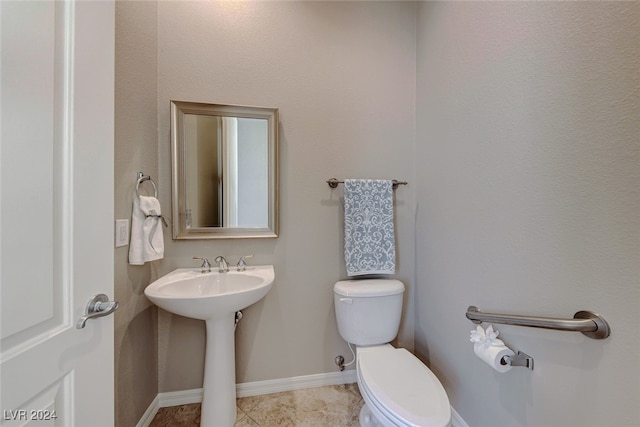 bathroom with tile patterned floors, toilet, and sink