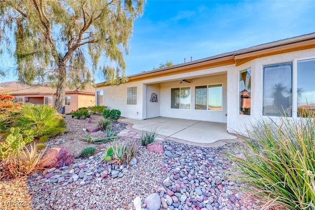 view of front of property featuring ceiling fan and a patio