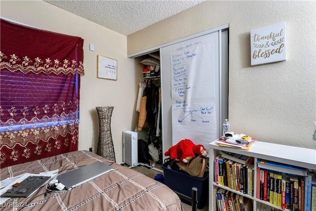 bedroom with a textured ceiling and a closet