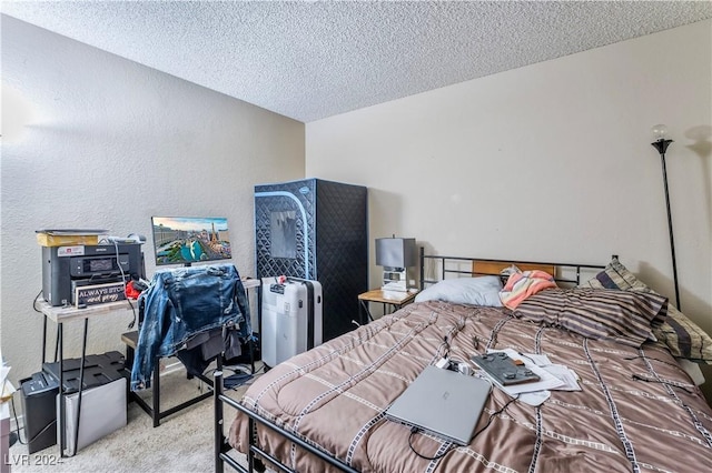 bedroom featuring carpet floors and a textured ceiling