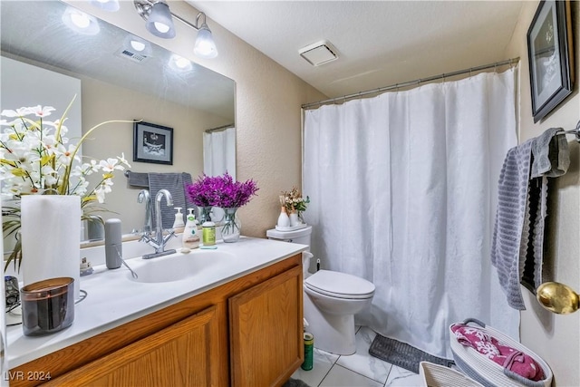 bathroom with tile patterned floors, vanity, and toilet