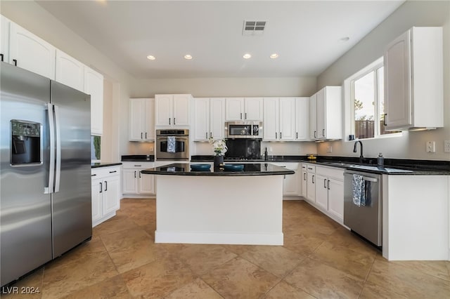 kitchen with a center island, white cabinetry, and appliances with stainless steel finishes