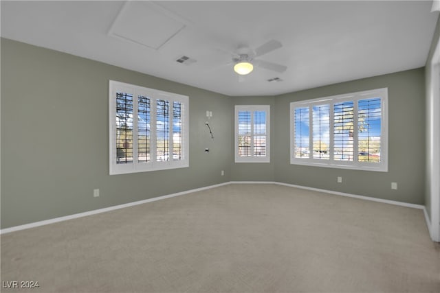 empty room featuring light colored carpet and ceiling fan