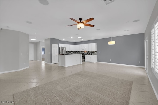 unfurnished living room with ceiling fan and light tile patterned flooring