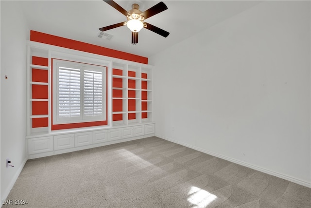 unfurnished room featuring ceiling fan and light colored carpet